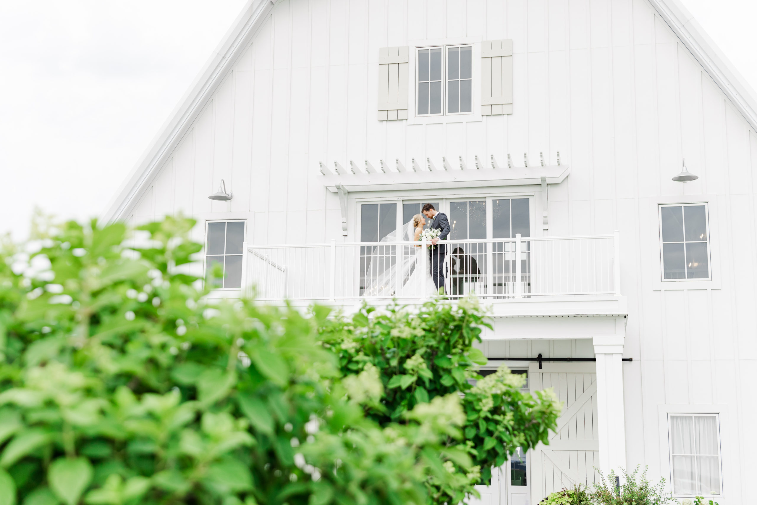 bride and groom on balcony at providence vineyard