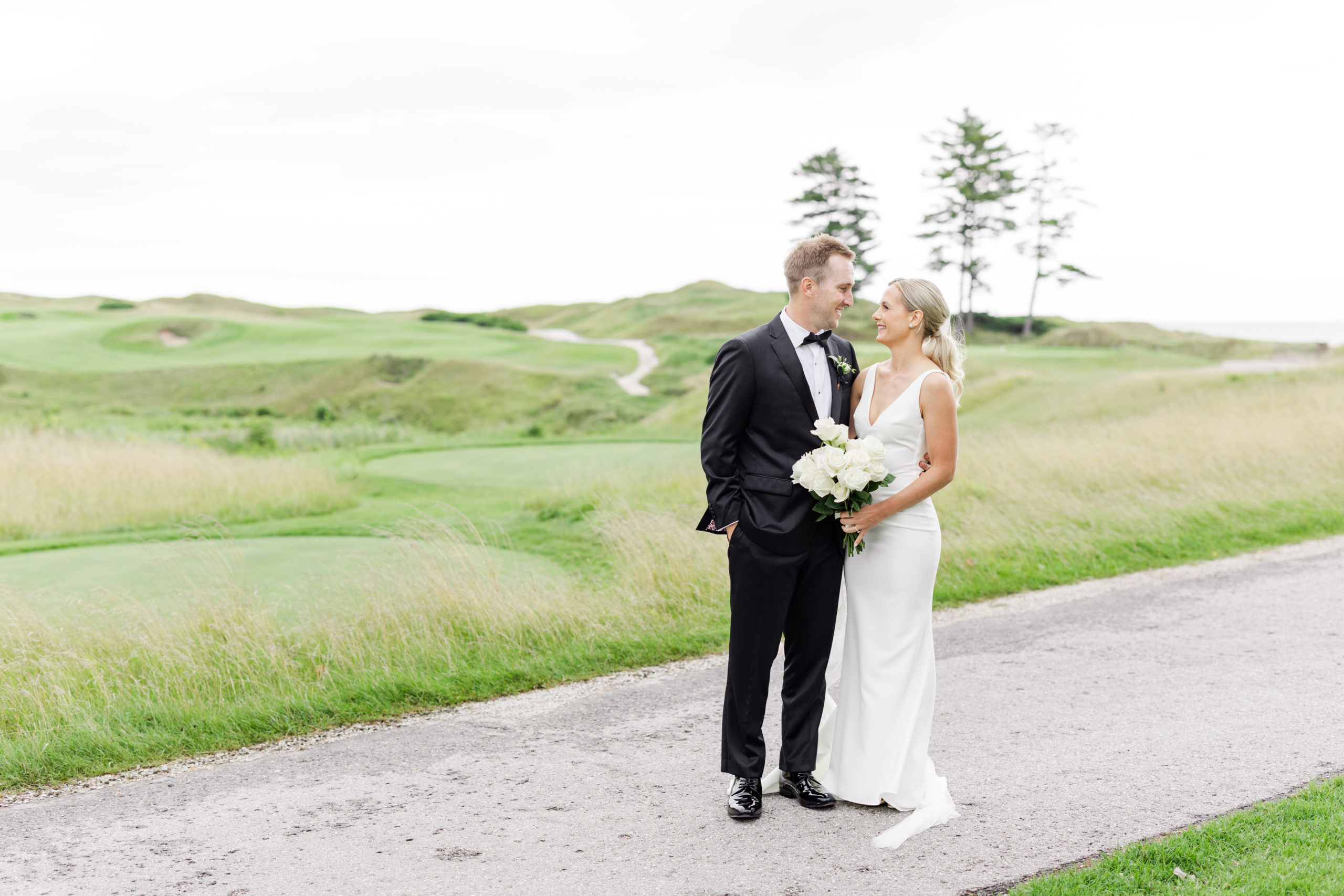 couple looking at each other at whistling straits in sheboygan wisconsin