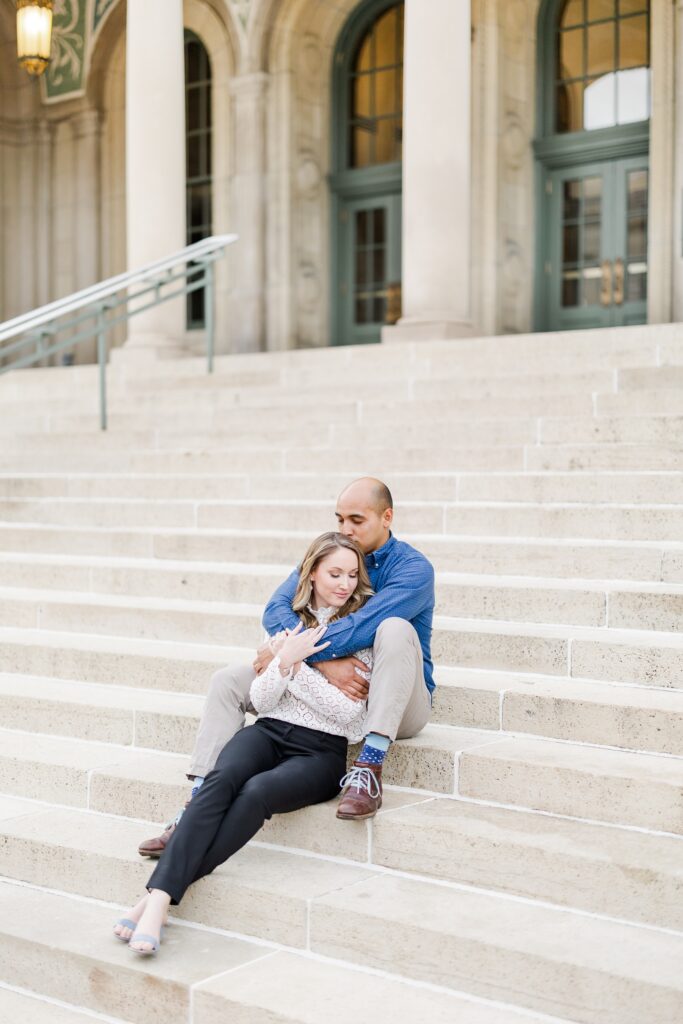 couple sitting on the steps at the memorial union for an engagement session