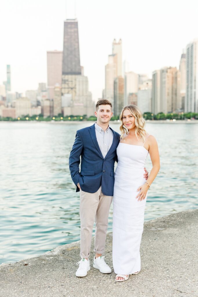 couple standing in front of the chicago skyline at north avenue beach