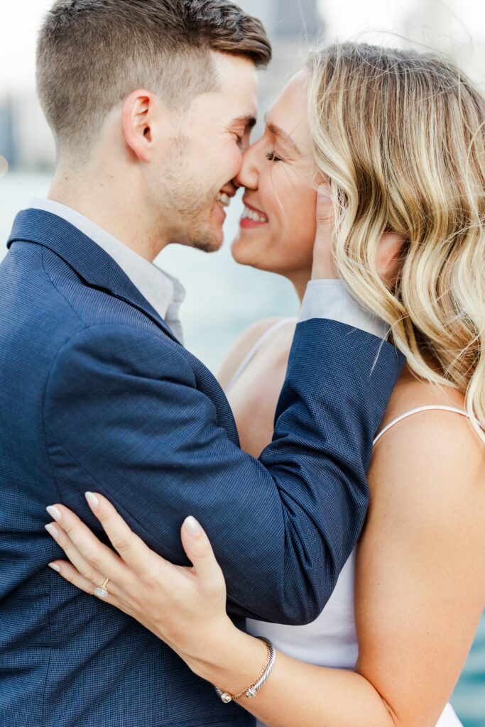 groom holding onto brides face smiling after a kiss