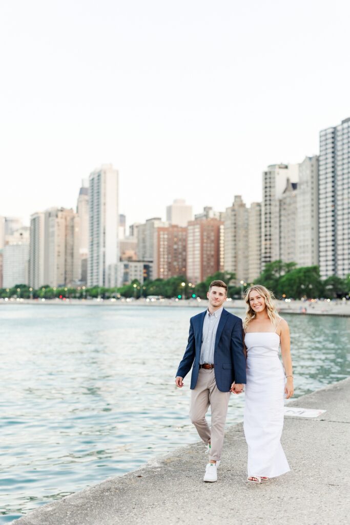 couple walking towards the camera holding hands in chicago illinois