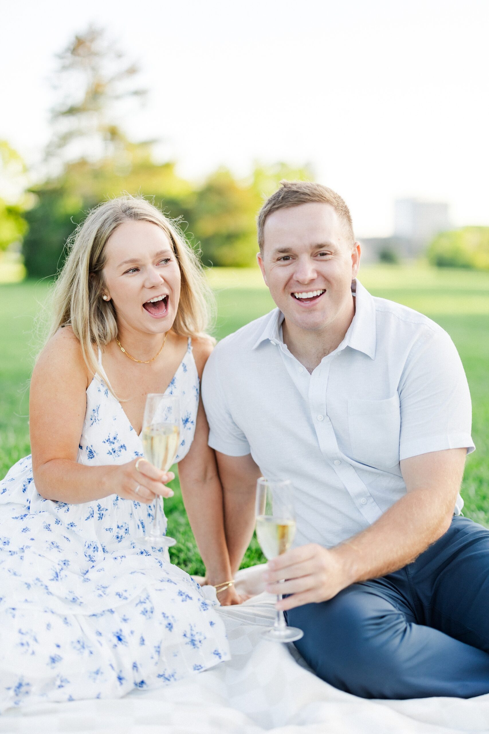 couple laughing during engagement photos in milwaukee