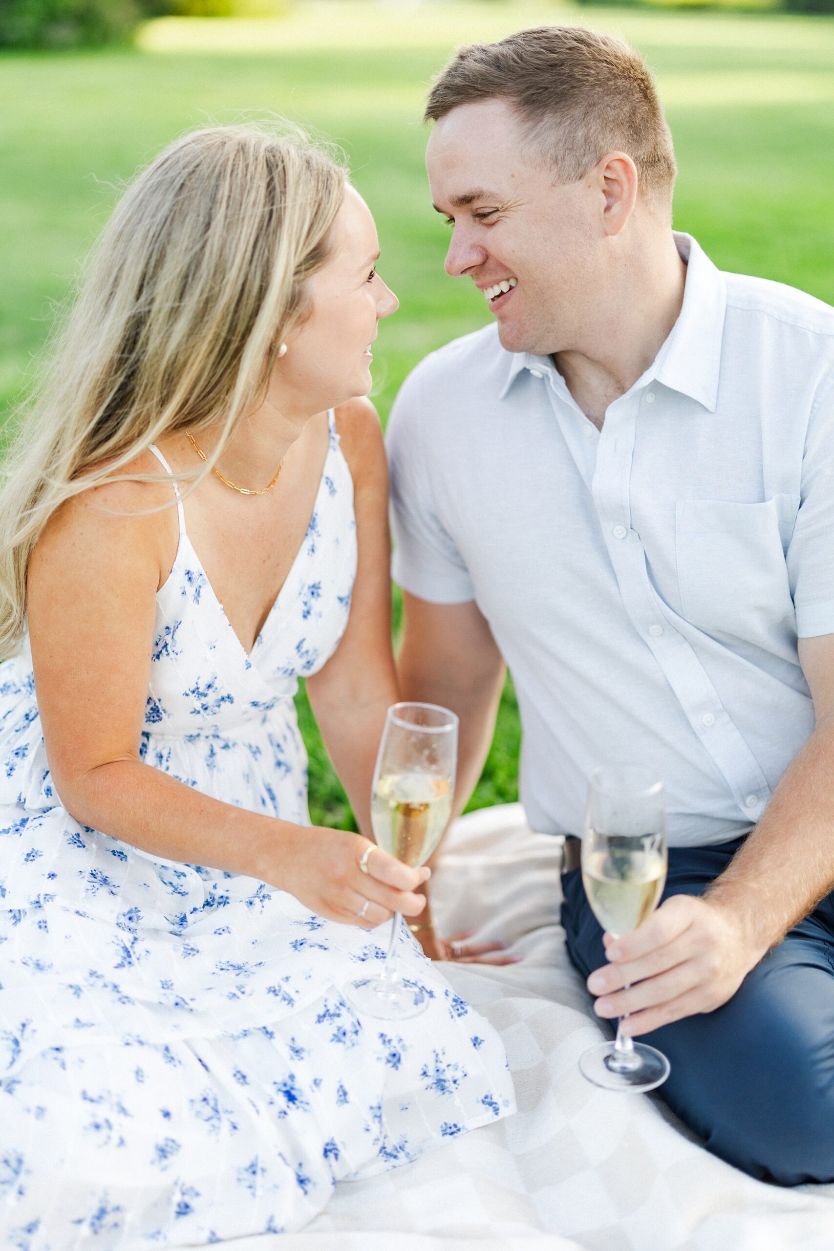 couple smiling at each other while holding champagne flutes