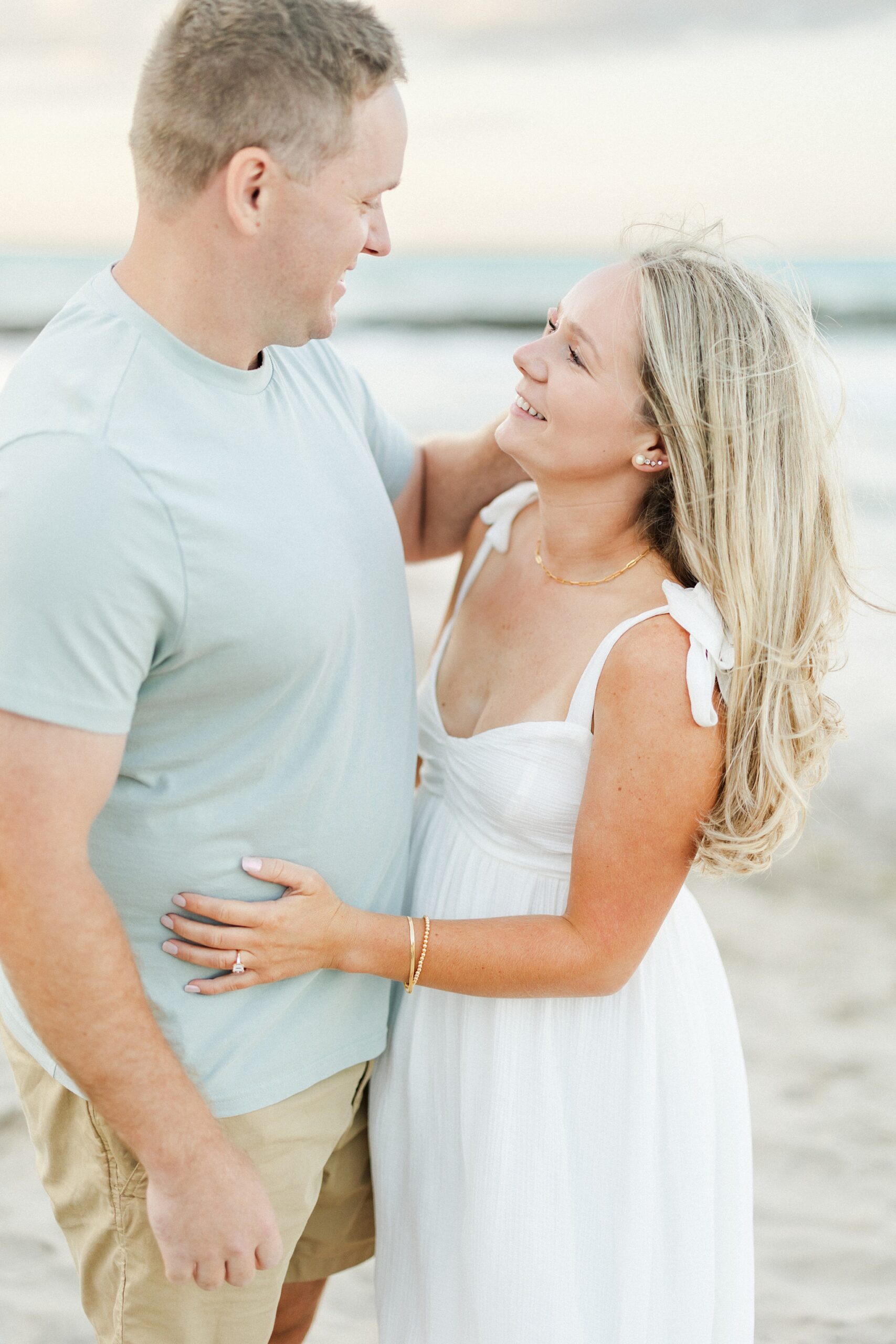 coastal engagement session couple looking at each other