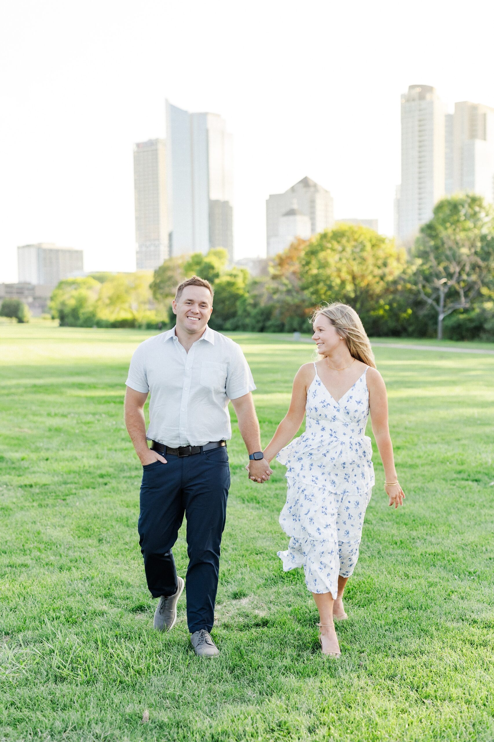 couple holding hands while walking at veterans park