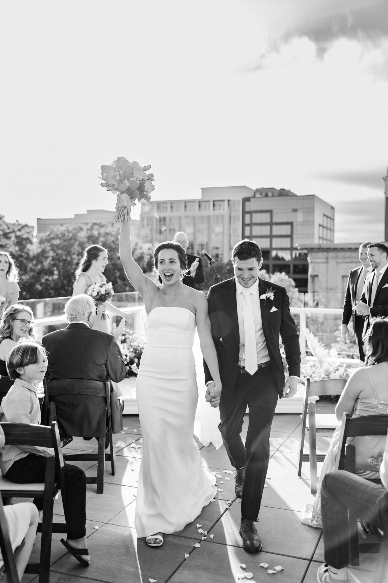 couple doing their recessional after their rooftop wedding ceremony